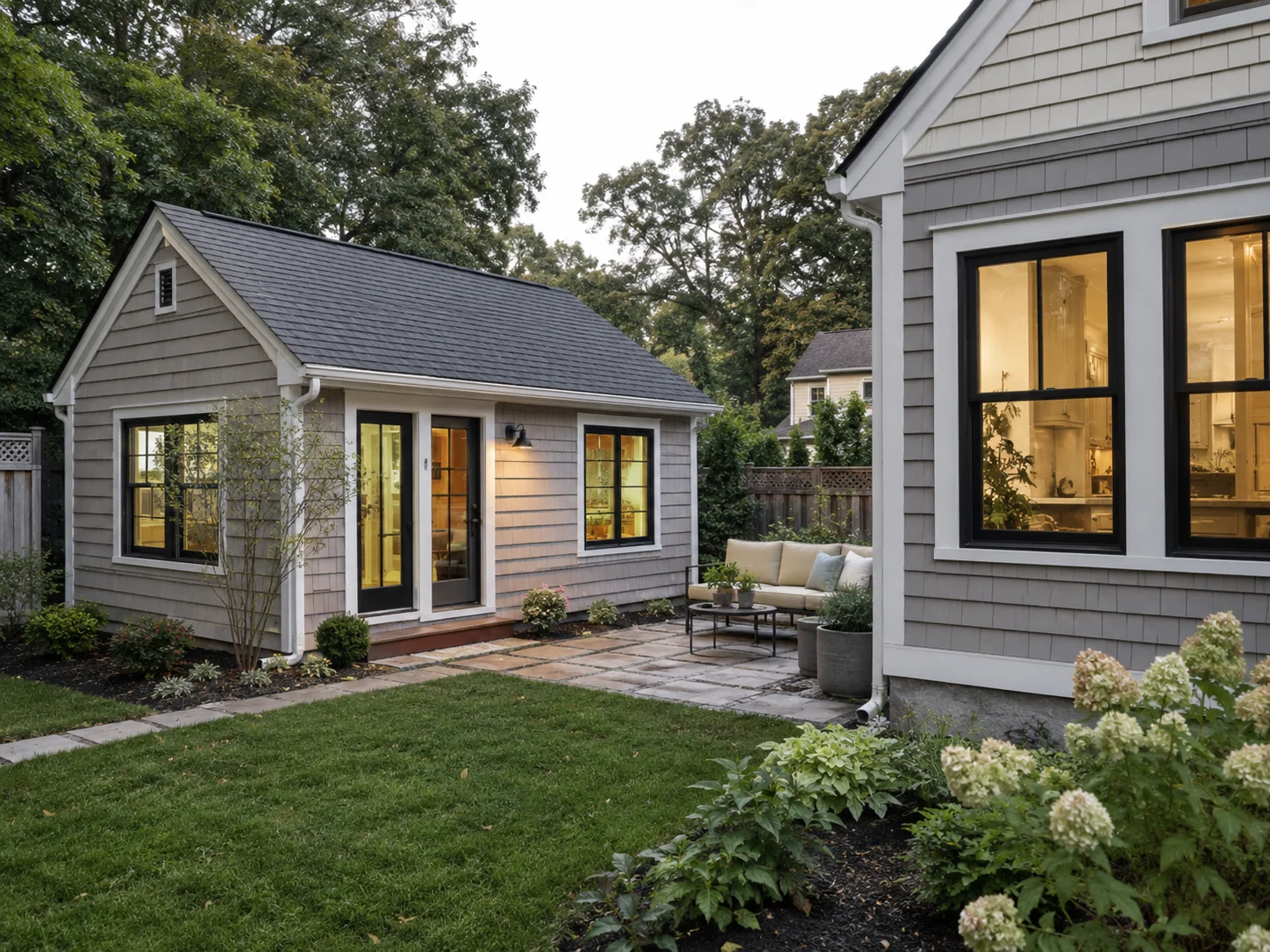 Detached New England accessory dwelling unit with patio seating.