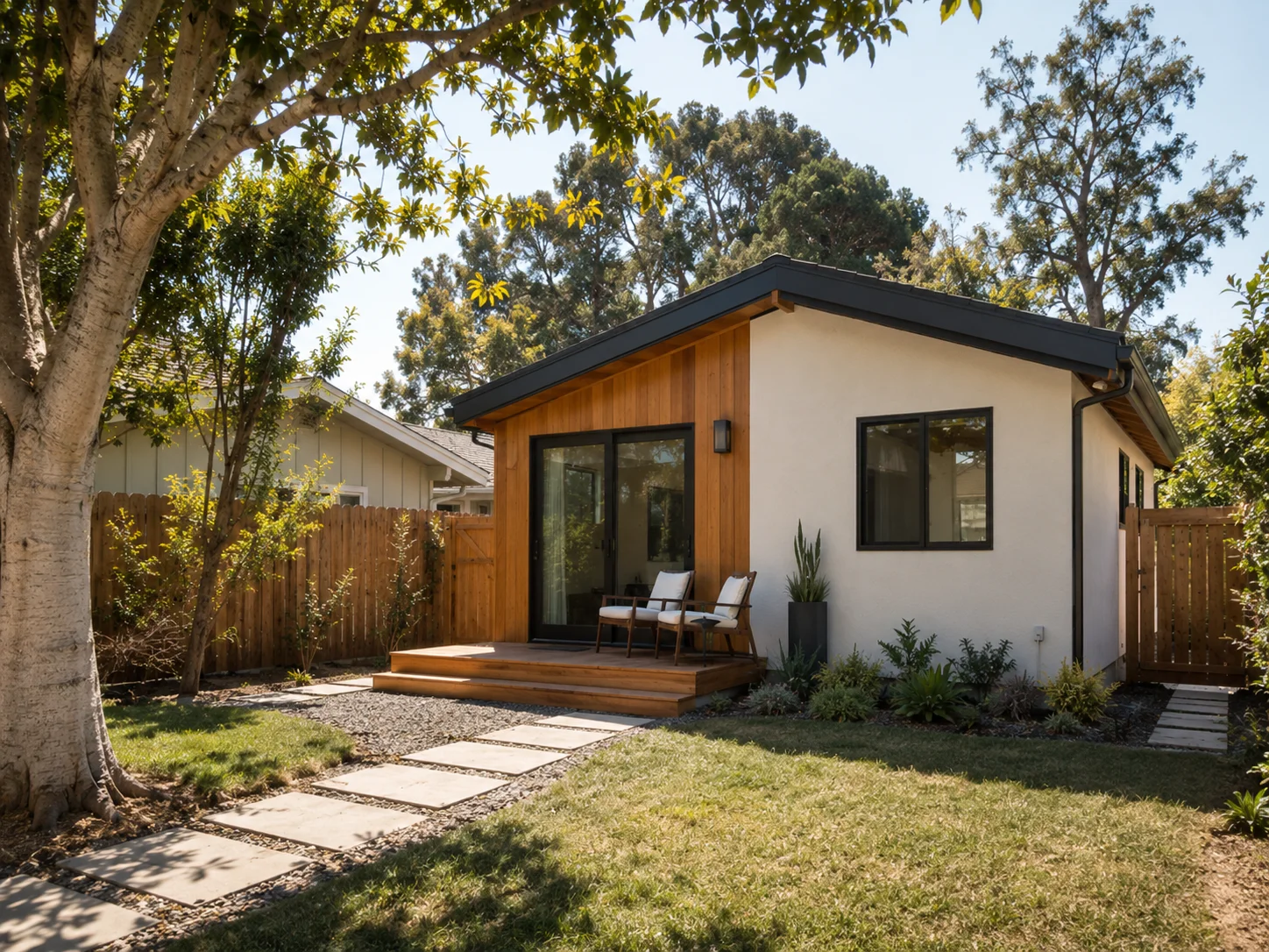 Compact detached new-construction ADU with shed roofline and wood deck in a San Diego County backyard